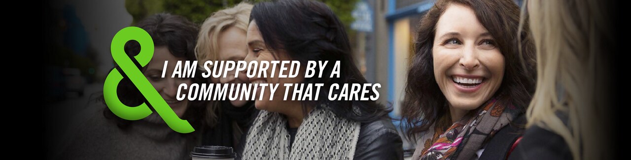 Image of a woman in a car with text that says – I AM SUPPORTED BY A COMMUNITY THAT CARES