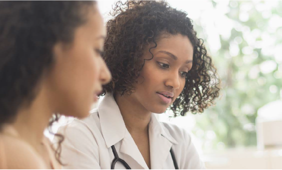 Image of a woman and a healthcare professional looking at something together
