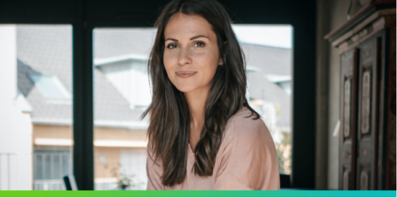 Image of woman in pink sweater with text that says - WE ARE TAKING ON MS & WE ARE STILL WRITING OUR STORIES